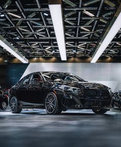 two black cars parked in front of each other