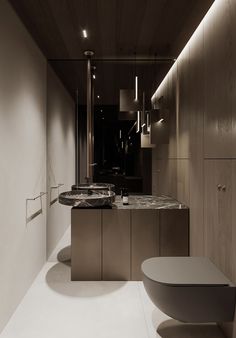 a modern bathroom with an oval sink and marble countertop, along with wood paneling on the walls