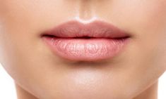 a woman's lips are shown with the tip of her lip sticking out to the side