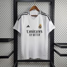 the real madrid jersey hangs on a rack in the dressing room at their home team's stadium