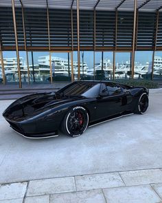 a black sports car parked in front of a building