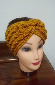 a mannequin head wearing a yellow knitted headband