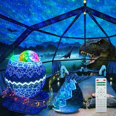 an image of a dinosaur in a tent with remote controls and lights on the ground