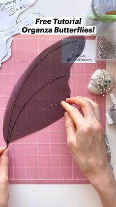 a person is making a paper feather decoration