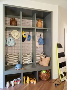 a room with some shelves filled with hats and purses