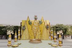 an outdoor wedding setup with yellow and white decorations