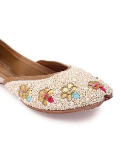 We created this pair with Pearl and Goota Work. Pair it with any traditional outfit or casual salwar kameez for a beautiful pubjabi Jutti look. Color: White Fabric: Upper: Saturn with intricate pearl and Gota work Insole - Leather Sole - Vegetable tanned Leather Sole Note: The product will be shipped within 20-25 days of the order placed Any slight irregularities are distinctive and are inherent to the beauty of this creation as it is precisely crafted by hands. Care intructions - Keep in dust b Traditional Semi-stitched Wear With Pearl Embroidery, Semi-stitched Traditional Wear With Pearl Embroidery, Diwali Traditional Wear With Pearl Embroidery, Fitted Traditional Wear With Pearl Embroidery For Festivals, Bollywood Style Traditional Wear With Pearl Embroidery, Bollywood Traditional Wear With Pearl Embroidery For Festive Occasions, Bollywood Style Festive Traditional Wear With Pearl Embroidery, Bollywood Traditional Wear With Pearl Embroidery For Festivals, Traditional Festive Wear With Pearl Embroidery