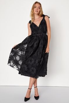 If you're looking for a dress that will always impress, you need the Lulus Definition of Drama Black Floral Applique Tie-Strap Midi Dress! Stretchy, lightweight mesh fabric (with subtle Swiss dots) features an applique ribbon design that shapes tonal flowers of varying sizes. Tying shoulder straps support a darted surplice bodice with a V-back and a satin ribbon detail at the fitted waist. Skirt boasts a classic A-line silhouette with a hidden layer of tulle for volume. Hidden zipper/clasp at ba Sheer Lace Summer Prom Dress, Sheer Lace Dress For Summer Prom, Chic Summer Lace Prom Dress, Sheer Lace Midi Dress For Summer, Sheer Lace Evening Dress For Summer, Sheer Lace Summer Evening Dress, Sheer Lace Dress For Summer Evening, Elegant Mesh Dress With Spaghetti Straps For Spring, Elegant Spring Mesh Dress With Spaghetti Straps