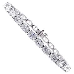 From Pampillonia jewelers, 27 perfectly matched oval diamonds lined up end to end form a straight line of diamonds. The 27 diamonds weigh 11.50 carats and are E-F color and are VS2+ clarity, set in 18 karat white gold. The bracelet is 6 ¾ inches and is available in any length. Pampillonia custom creates diamond bracelets in a variety of diamond shapes and sizes Luxury Oval Tennis Bracelet In Fine Jewelry Style, Luxury Oval Cubic Zirconia Bracelet, Oval Bracelet Diamond, Luxury White Oval Diamond Bracelet, Oval Diamond Bracelet With 17 Jewels, Luxury Diamond White Oval Diamond Bracelet, Luxury Oval Diamond White Diamond Bracelet, Diamond Tennis Bracelet With Oval Link And Accents, White Gold Oval Tennis Bracelet With Prong Setting