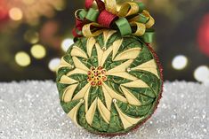 an ornament shaped like a christmas ball with a bow on it's top