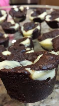 chocolate cupcakes with white frosting on a marble counter top, ready to be eaten