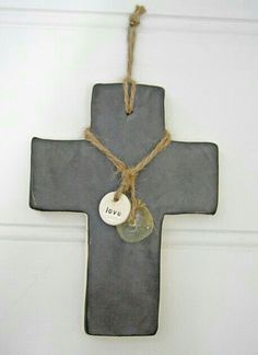 a cross hanging on the wall with a tag that says love