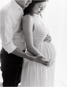 a pregnant couple standing next to each other