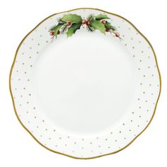 a white and gold plate with holly decorations