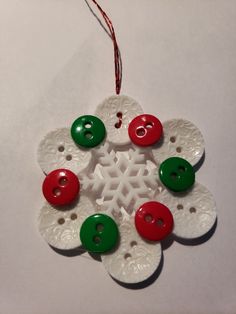 a snowflake ornament with buttons on it