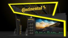 an exhibition booth with the words continental on it's front and side walls, lit up at night