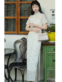 A stunning (and fully customizable) qipao, made from 100% ramie plant fiber and lined with pure cotton. The Yi Xiao 伊笑 Carefree Qipao offers a breathable and lightweight feel that's perfect for any occasion. The double-layered design means there's no need for a petticoat, one less layer to worry about! The light blue color, adorned with a delicate floral print, adds a touch of subtle charm and grace. Ideal for garden parties, casual outings, or an evening event, this dress combines timeless styl Elegant Embroidered Cheongsam For Spring, Traditional White Cheongsam With Stand Collar, Traditional White Fitted Cheongsam, Fitted Embroidered White Cheongsam, Traditional White Cheongsam For Spring, White Summer Cheongsam With Stand Collar, Summer White Cheongsam With Stand Collar, Fitted Floral Embroidery Cheongsam For Summer, Summer Floral Embroidered Fitted Cheongsam