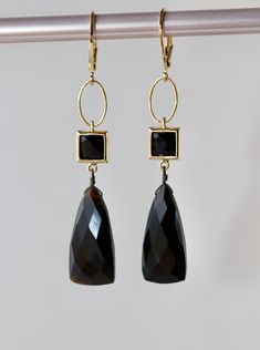 "Faceted Black Onyx Triangle shape stones size 20 x 10 mm. Square Connectors with Black Synthetic Faceted Glass Stones 7 x 7 mm in Gold plated over the brass setting.  Gold plated Lever Back Clasps. The total length is 2.25 inches or 58 mm long.  Your order will be gift wrapped and shipped in jewelry gift box.  If you would like to order this item as a gift you can leave a personalized note for the receiver during a checkout process, there will be \"Gift  details\" option to add a message. * * * Black Faceted Jewelry For Party, Black Faceted Earrings As A Gift, Black Onyx Earrings For Parties, Elegant Onyx Earrings, Formal Black Onyx Earrings, Elegant Hand-strung Onyx Jewelry, Faceted Black Earrings Gift, Elegant Onyx Dangle Earrings, Elegant Hand-strung Obsidian Jewelry