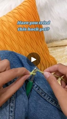 someone is knitting something on the bed with their fingers and thumbnails in front of them