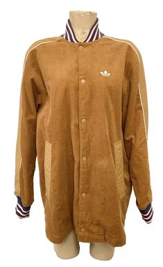 Very nice Men's Adidas jacket size medium. It's dark beige corduroy with blue, white and red around the neck and arm openings. There are pockets. Snaps down the front. Very nice. NWT priced $120.00. No defects that I can see. Message me with any questions or if more measurements are needed.  Always check measurements  Approximate measurements: chest: 24" armpit to armpit, length: 27" top of shoulder to bottom side. Tag reads: 100% polyester Feel free to check out my other items! Happy to combine shipping! Must combine shipping prior to payment.  Matching Prices: For all store listings I will match prices!! Just send me a link or an item number for the same item that is listed cheaper here on eBay!! ***International buyers: I cannot ship directly to other countries, but I will use eBays new Brown Cotton Outerwear With Ribbed Collar, Brown Hooded Corduroy Outerwear, Adidas Cotton Outerwear With Ribbed Cuffs, Brown Corduroy Outerwear For Streetwear, Beige Corduroy Jacket, Adidas Beige, Dark Beige, Corduroy Jacket, White And Red