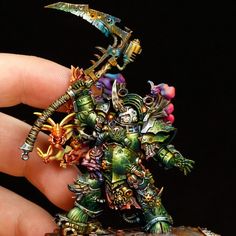 a person holding a miniature warhammer in their hand