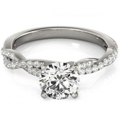 a white gold engagement ring with a twisted band and a round brilliant diamond center stone