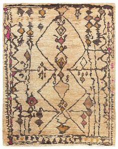 an old rug with blue and beige designs on the front, in various colors and shapes