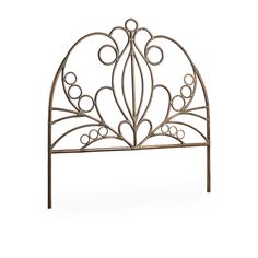 a metal headboard with circles and scrolls on it's sides, against a white background