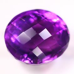 a large purple stone sitting on top of a white table