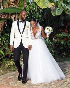 a man and woman in formal wear walking together