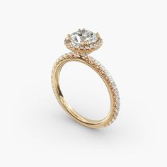 a yellow gold engagement ring with an oval diamond center