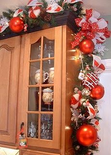 a christmas display with red and white ornaments on the top, along with other holiday decorations