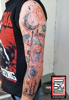 a man's arm covered in colorful tattoos and inking on his left arm