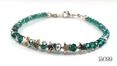 Petite shiny silver tone stars alternating with 4 mm rondelle crystals that are half peacock green and half silver.  The sides of the bracelet are a string of six more half green/half silver rondelles, then a longer string of 3 mm sparkly faceted peacock green rondelle crystals. This beaded bracelet is strung on a heavier gauge wire that holds it shape, similar to a bangle. Lobster claw clasp Length:  17.7 cm / 7 inches Item # 15099 Adjustable Sparkling Silver Beaded Bracelet, Green Sterling Silver Beaded Bracelet, Green Beaded Sterling Silver Bracelet, Sparkling Silver Beaded Bracelets With Round Beads, Silver Sparkling Beaded Bracelets With Round Beads, Sparkling Silver Beaded Bracelets, Adjustable Faceted Bead Bracelets For May Birthstone, Green Sterling Silver Bracelets With Silver Beads, Green Sterling Silver Bracelet With Silver Beads