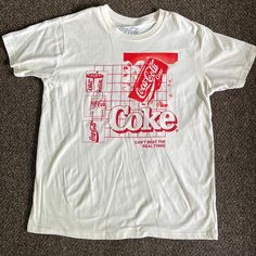 Brand New And Never Worn! Cream And Red Coca-Cola T-Shirt. No Rips Or Stains! Size: L Red Casual T-shirt With Graphic Design, 90s Red T-shirt With Text Print, Red Crew Neck Top With Graphic Design, Casual Red Tops With Graphic Design, Retro Red Tops With Text Print, Casual Crew Neck Shirt With Graphic Design, Casual Red Tops With Graphic Print, Casual Red Top With Graphic Print, Casual Red Shirt With Screen Print