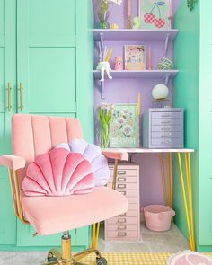 a pink chair sitting in front of a green book shelf