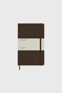 a brown and white notebook sitting on top of a table