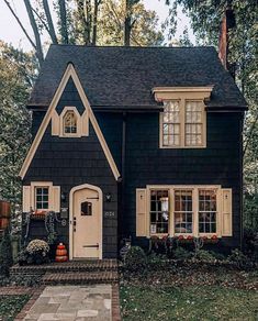 a black house with white trim and windows