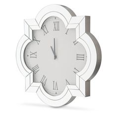 a white clock with roman numerals on it's face and numbers in the middle