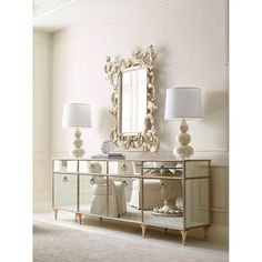 a mirrored cabinet with two lamps and a mirror on the wall in front of it