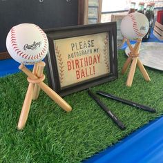 baseballs and bats are on display in front of a sign that says please autograph my birthday ball