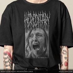 A tribute to Hereditary, the award winning 2018 film by Ari Aster and A24, redesigned into the style of Black Metal band merchandise. Featuring a drawing of a screaming Annie Graham (played by Toni Collette), adorned with a custom black metal logo and the films tagline in a gothic blackletter font.  "Evil runs in the family" 📏 Sizing  * Printed on Gildan 5000 - Adult Unisex Heavy Cotton T-Shirts * Please check the sizing chart in our images before purchasing * We recommend purchasing x1 size up for a relaxed fit * Or x2 sizes up for an oversize fit. 💶 Refunds and Returns * Please note that as each product is made-to-order, we do not accept refunds or exchanges * In the event of your product being damaged or incorrect, we will provide you with a replacement or full refund if you send us a Toni Collette, Blackletter Font, Band Merchandise, Horror Film, Metal Band, Metal Logo, Metallic Logo, Horror Films, Sizing Chart