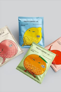 three packets of fruity coffee on top of each other, one in the shape of an orange