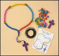 a rosary, bracelet, and cross on a table