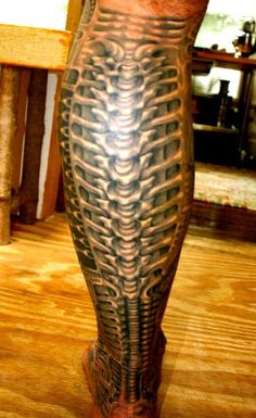 a man's leg with an intricate tattoo on it