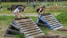 two children are playing in an obstacle course