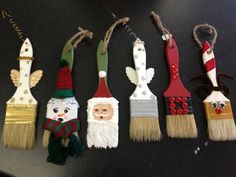 a row of christmas themed brushes sitting on top of a black table next to each other