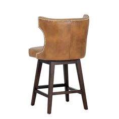 a brown leather bar stool with studding on the armrests and foot rest