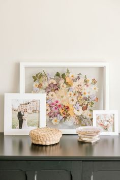 16x20 white wood pressed flower frame displayed next to photographs from the special day accompanied by a resin ring dish. Framed Bouquet, Preserved Wedding Bouquet, Pressed Bouquet, Wildflower Wedding Theme, Modern Bouquet, Event Florals, Pressed Flower Frame, Wedding Bouquet Preservation, Pressed Flower Crafts