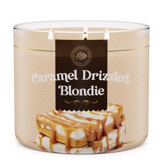 caramel drizzled blondie cake in a glass jar on a white background